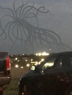 an octopus is seen in the back window of a car as traffic passes by at night