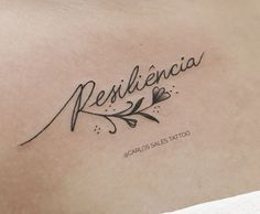 a tattoo that reads resilicia on the chest