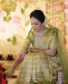 a woman sitting down in a green dress