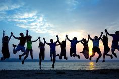 a group of people jumping into the air