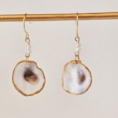 These beautiful earrings are created using Small Oyster  shells.  Hook earrings gold finish. They have a stunning Pearl accent stone on a silver hook.  Made by yours truly,               Becca Pearl Shell Earrings Perfect For Gifts, Shell Shaped Pearl Earrings For Gift, Pearl Shell Earrings For Gift, Shell Pearl Drop Earrings As Gift, Gold Shell With Matching Earrings Gift, Shell Pearl Drop Earrings For Gifts, Pearl Drop Shell Earrings For Gift, Gold Shell Pearl Earrings As Gift, Gold Shell Earrings With Ear Wire As Gift