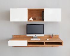 a computer monitor sitting on top of a wooden desk