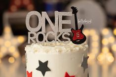 a white cake topped with a guitar and stars