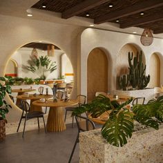 an indoor restaurant with potted plants and tables