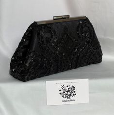 Your wedding or special occasion outfit will be complete, with this small black sequin lace evening bag clutch purse handbag.  The black sequin lace mesh is overlaid on black dupioni satin.  The 5 1/2" frame is available in gunmetal black or light gold hardware, and it has chain loops for an optional 18" chain strap attachment.     Height is 4 1/2", length at top is 5 1/2", length at bottom is 9", and it expands to a width of 2" at the bottom.   The clutch has body and stands by itself.  This cl Occasion Outfit, Wedding Bags, Chain Loop, Small Makeup, Black Clutch, Special Occasion Outfits, Wedding Bag, Makeup Items, Accessories Bags Purses