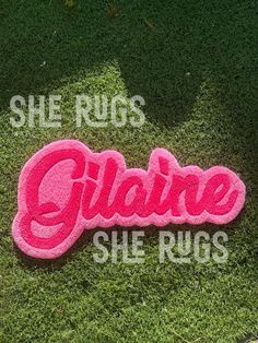 there is a pink sign that says glame she rugs on the grass