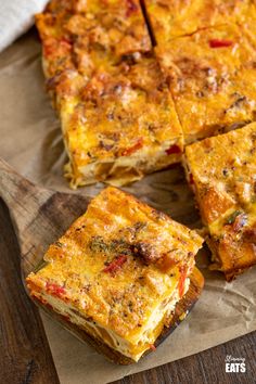 several slices of pizza sitting on top of a wooden cutting board