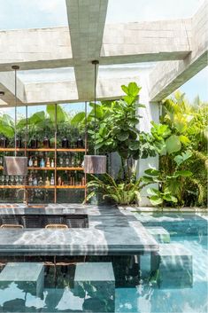 an outdoor dining area next to a swimming pool