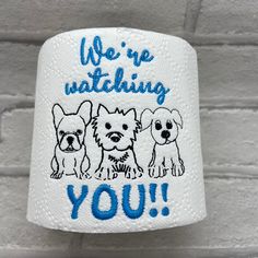 a white canister with three dogs on it that says we're watching you