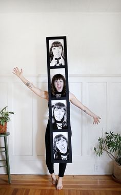 a woman standing in front of a mirror with pictures on it's face and arms