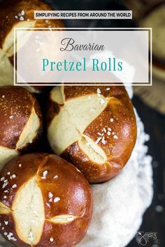 three pretzel rolls sitting on top of a white plate with the words bavarian pretzel rolls