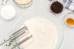 the ingredients for chocolate chip cookies are in bowls and ready to be mixed into batter