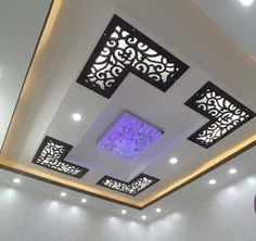 the ceiling is decorated with black and white designs, which are accented with purple lights