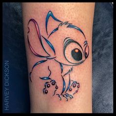 a small tattoo on the leg of a person with an evil looking eye and tail