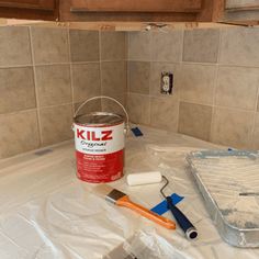 a bucket of paint sitting on top of a counter