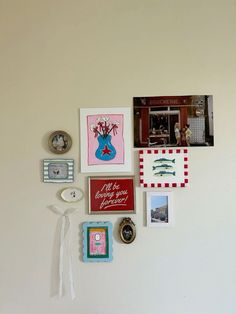 the wall is covered with pictures, magnets and other things that are hanging on it