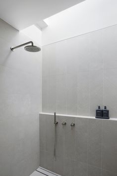 a bathroom with a shower head, toilet and hand held shower faucet in it