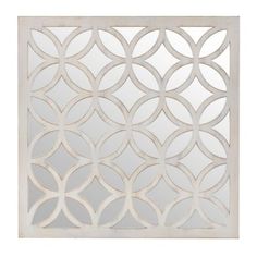 a decorative mirror with an intricate design on the front and back panel, in white