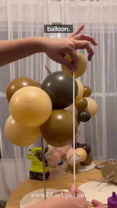 someone is decorating some balloons on the table