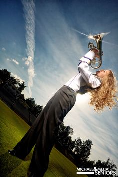 a woman is playing the french horn