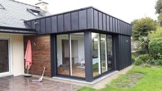 a modern house with an open patio and sliding glass doors on the front door area