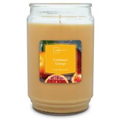 a candle that is filled with oranges and other fruity things on the table