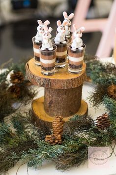 the desserts are decorated with pine cones and bunny figurines on top of each other