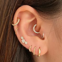 a close up of a person with ear piercings on their left and right sides