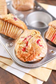 three muffins sitting on top of a metal tray next to a cupcake tin