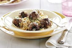 a plate with meatballs and noodles on it