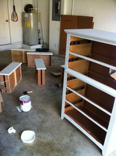 an empty room with several wooden shelves and tools on the floor next to each other