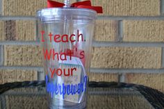 a tumbler cup with writing on it and a red bow