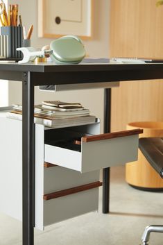 an office desk with drawers underneath it