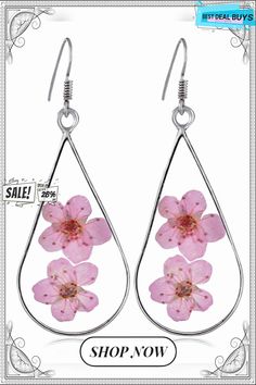 earrings with pink flowers on them are shown in front of an advertisement for the shop now