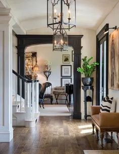 the inside of a house with wood flooring and sliding doors leading to other rooms