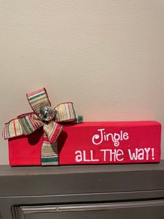 a red box with a bow on it that says, simple is all the way