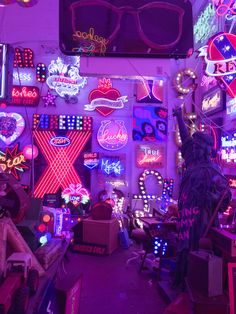 a room filled with lots of neon signs and decorations