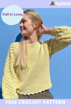 a woman wearing a yellow knitted sweater with scalloped edges and a round hole in the middle