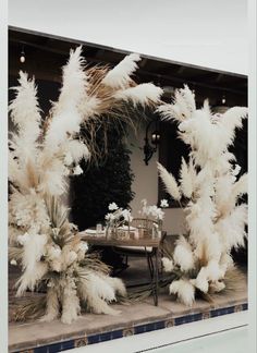 an outdoor dining area with tall white pamodia