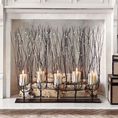 candles are lined up in front of a fireplace with branches on it and the words pint written above them