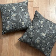 two pillows sitting on top of a wooden floor