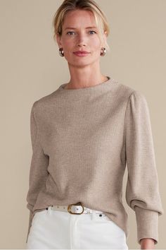 We refreshed the classic waffle knit top with a modern silhouette, featuring puff sleeves with deep cuffs and an architectural neckline. And then there's the shimmer. Touches of silver sparkle are woven into the taupe knit for a cool, subtly festive look. Elegant Knit Top With Ribbed Cuffs For Fall, Chic Knit Balloon Sleeve Tops, Chic Knit Tops With Balloon Sleeves, Elegant Neutral Tops For Winter, Elegant Beige Textured Knit Tops, Elegant Neutral Winter Tops, Elegant Puff Sleeve Knit Top For Fall, Elegant Textured Tops For Fall, Elegant Long Sleeve Puff Sleeve Top For Winter