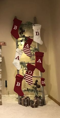 christmas stockings hanging from a ladder in the corner of a room