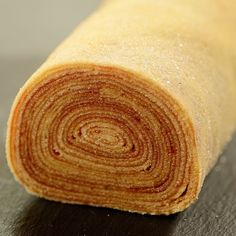 a rolled up piece of bread sitting on top of a table