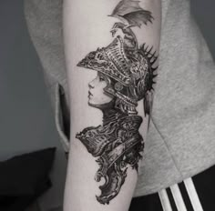 a woman's arm with an intricate tattoo design on the back of her head