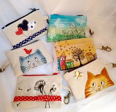 several small purses with cats on them