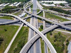 an aerial view of multiple roads in the middle of a highway with traffic on it