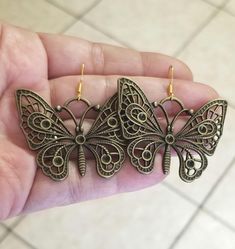 New  Handmade  Large Butterfly Earrings  These bohemian beauties are sure to make your heart flutter!   ♡ Chose from Bronze butterflies with 14k Gold over silver ear hooks (or) Stainless steel butterflies with .925 Sterling Silver ear hooks ♡ Stunning filigree detailed butterfly charms measure 1.5 inches tall x 1.5 inches wide ♡ Dangle length with hook measures 1.75 inches  ♡ Hypoallergenic, nickel free  Ships within 24 hours of cleared payment Monday-Saturday Gift Packaging & Messages: Your ite Bohemian Butterfly Jewelry For Festivals, Bohemian Butterfly Jewelry, Handmade Butterfly Metal Earrings, Handmade Metal Butterfly Earrings, Bohemian Butterfly Nickel-free Jewelry, Bohemian Butterfly Earrings For Pierced Ears, Gold Butterfly Jewelry For Festival, Bohemian Adjustable Butterfly Earrings, Bohemian Butterfly Jewelry With Pierced Design