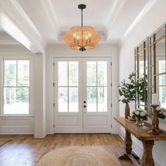 a foyer with wooden floors and white walls