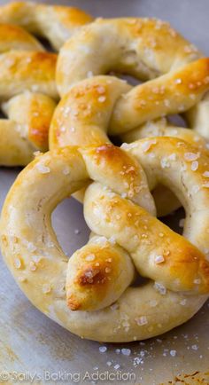 some pretzels are sitting on top of a baking sheet covered in sea salt